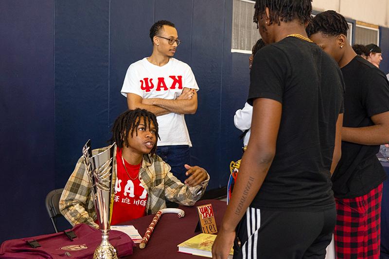 An FS life member at a recruitment table talking to another student